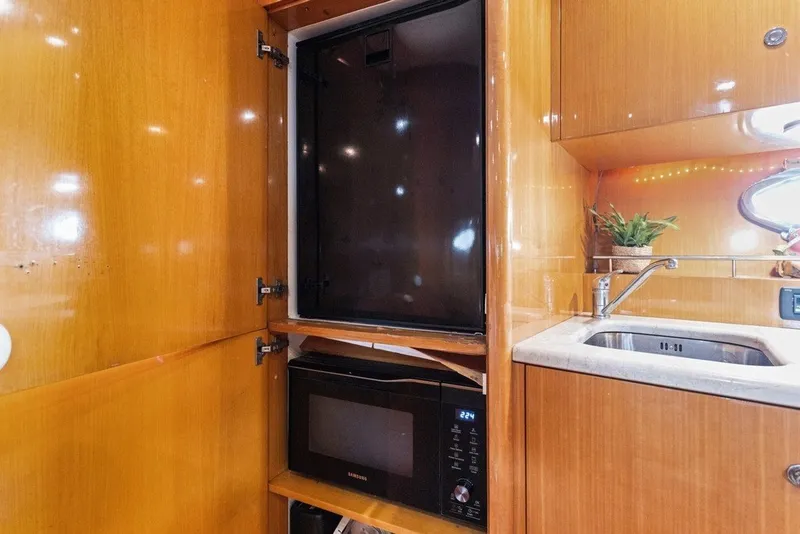 Slide: The Image of Kitchen area of 2005 Uniesse 54 Sport yacht with microwave and sink. - 13