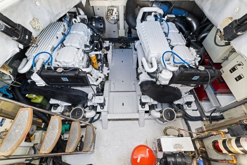 Slide: The Image of Engine room of 2005 Uniesse 54 Sport yacht, featuring dual engines and mechanical components. - 29