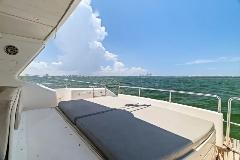 Slide: The Image of 2005 Uniesse 54 Sport yacht deck with ocean view and city skyline. - 24