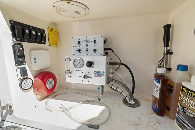 Slide: The Image of Control panel and maintenance supplies in a 2005 Uniesse 54 Sport yacht. - 32