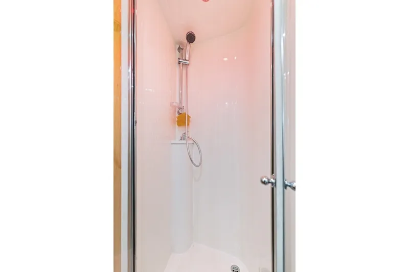 Slide: The Image of Shower area inside 2005 Uniesse 54 Sport yacht, featuring sleek design and modern fixtures. - 19