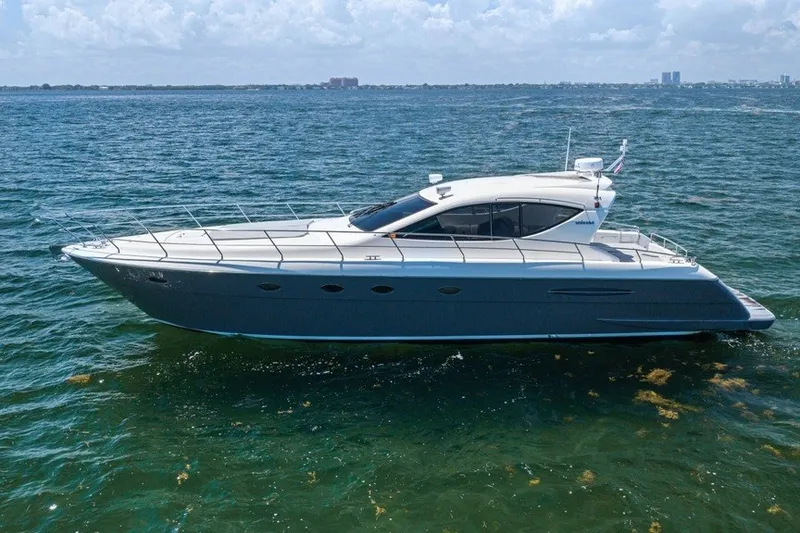 The Image of 2005 Uniesse 54 Sport yacht cruising on open water under a clear sky. - 4