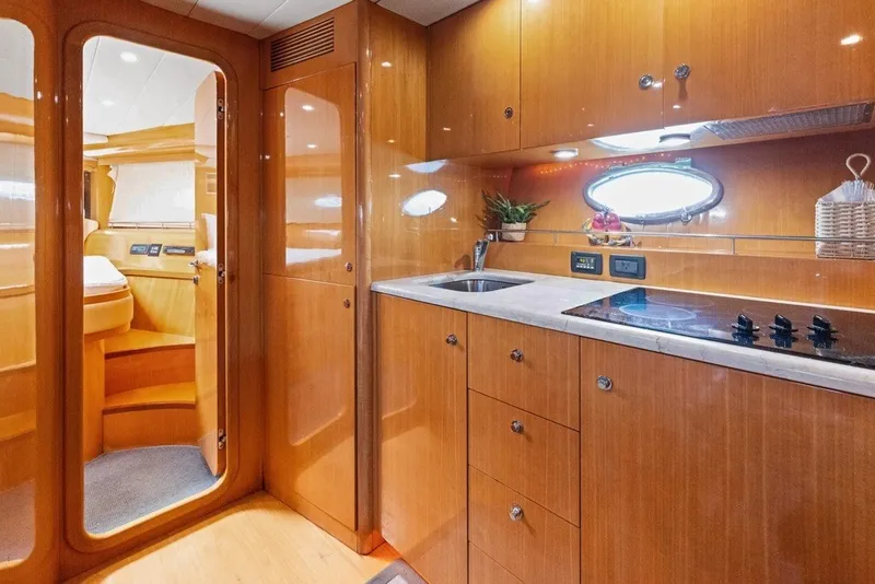 Slide: The Image of Luxurious 2005 Uniesse 54 Sport yacht interior with modern kitchen and wooden cabinetry. - 11