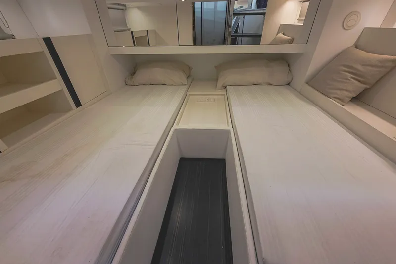 Slide: The Image of 2024 FIM 34 Regina interior cabin with twin beds and modern design. - 24