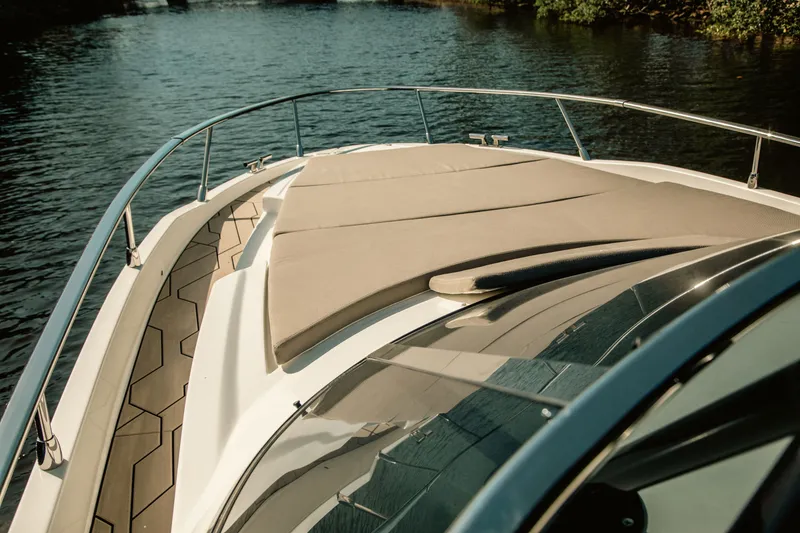 Slide: The Image of 2024 FIM 34 Regina boat deck with sunbathing area on calm water. - 30