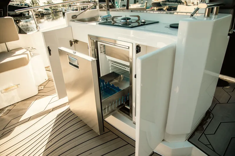 Slide: The Image of Outdoor kitchen on 2024 FIM 34 Regina yacht with open fridge and stove. - 16