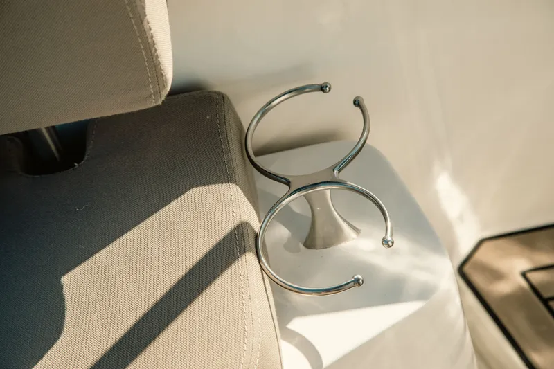 Slide: The Image of Cup holder on FIM 34 Regina 2024 boat, next to beige seating. - 13