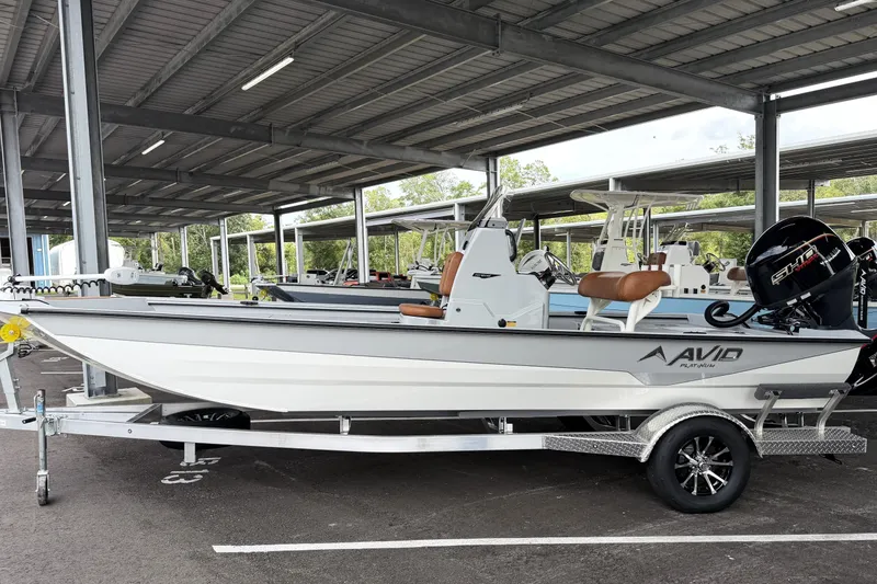Slide: The Image of Avid 207 Recon 2027 boat on trailer under covered parking. - 2