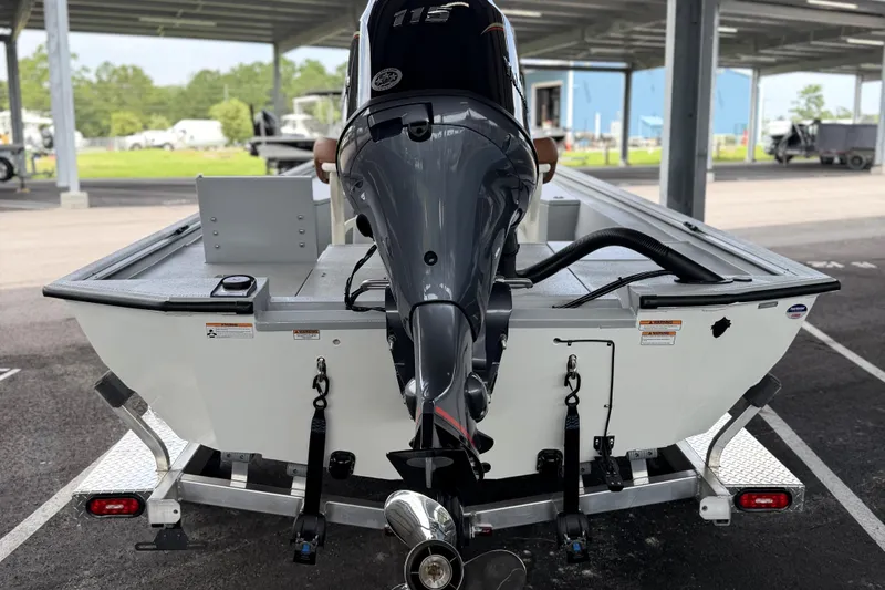 Slide: The Image of Avid 207 Recon boat, 2027 model, with powerful outboard motor in a covered parking area. - 11
