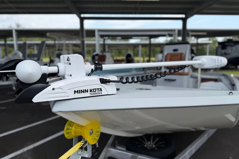Slide: The Image of Minn Kota Terrova motor on Avid 207 Recon boat, 2027 model, in a covered marina. - 18
