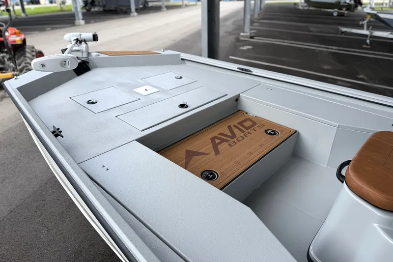 Slide: The Image of Interior of 2027 Avid 207 Recon boat with storage compartments and seating. - 17