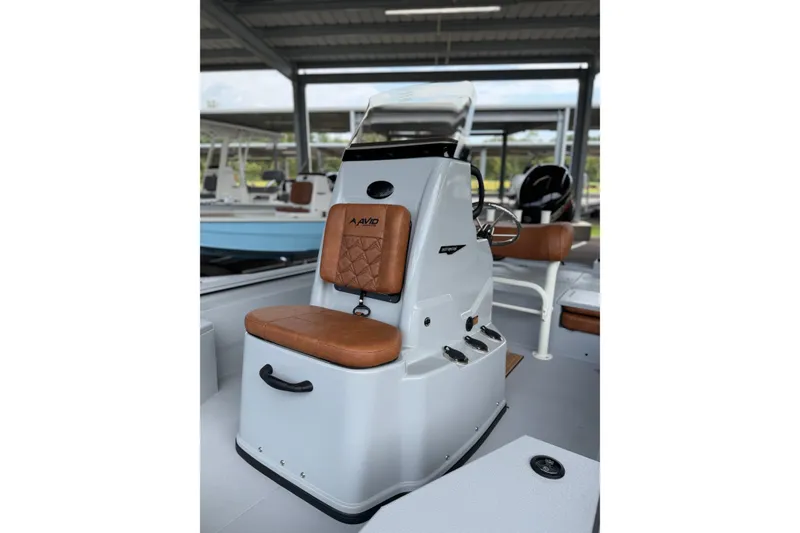 Slide: The Image of 2027 Avid 207 Recon boat interior with brown leather seating and modern controls. - 15
