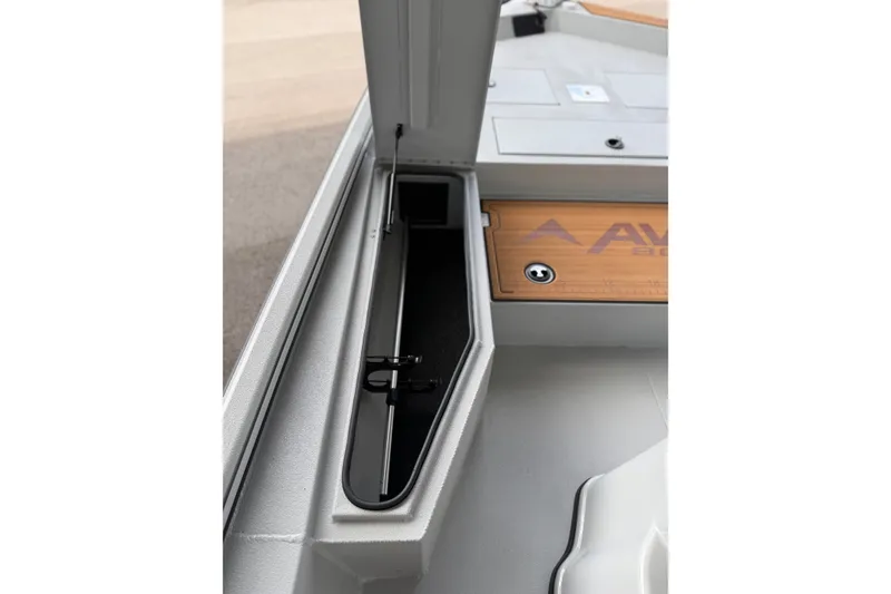 Slide: The Image of Interior view of 2027 Avid 207 Recon boat, showcasing storage compartment and sleek design. - 7