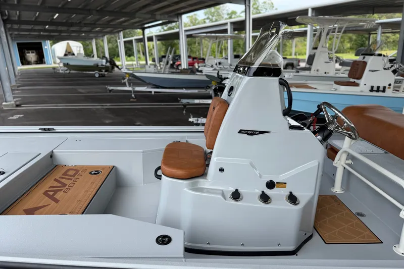 Slide: The Image of Avid 207 Recon boat interior with brown seating, under covered storage area. - 16