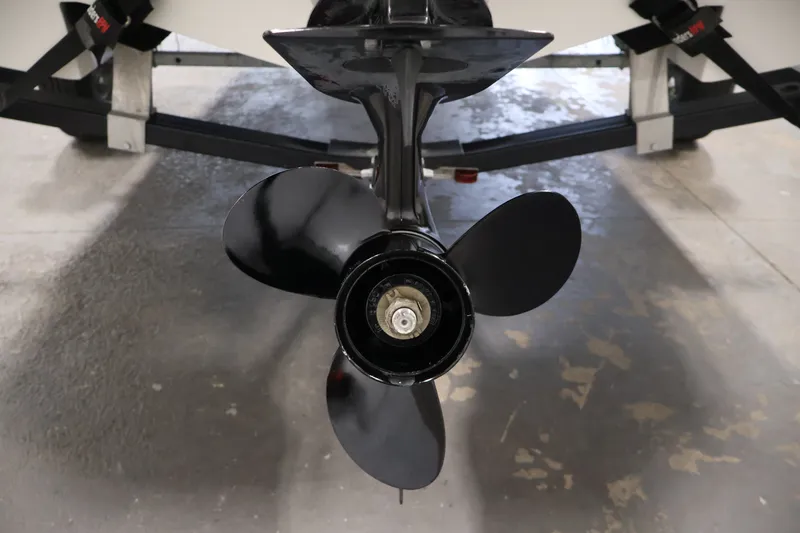 Slide: The Image of 2019 Bayliner Element 180 XL boat propeller, close-up view in a garage setting. - 36