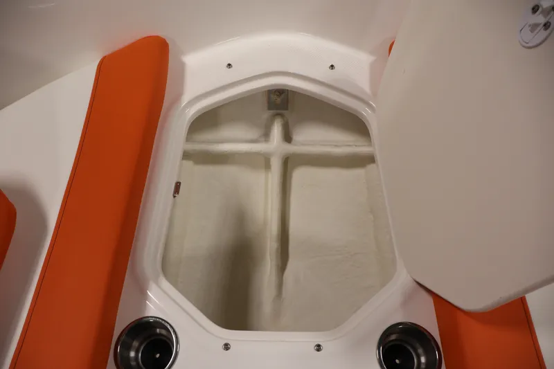 Slide: The Image of 2019 Bayliner Element 180 XL boat storage compartment with orange seating and cup holders. - 11