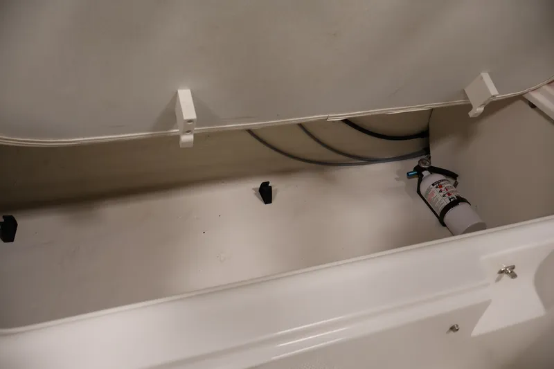 Slide: The Image of Storage compartment of 2019 Bayliner Element 180 XL with fire extinguisher. - 30