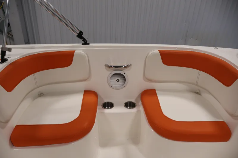 Slide: The Image of 2019 Bayliner Element 180 XL boat interior with orange seating and cup holders. - 26