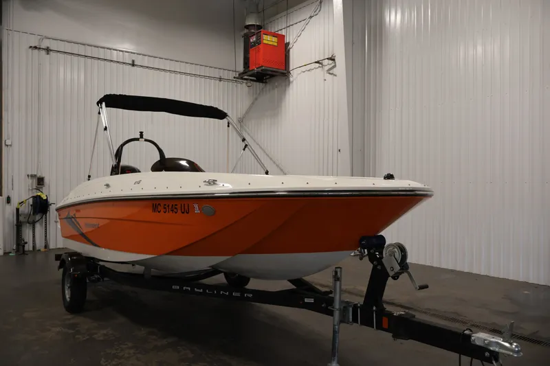 Slide: The Image of 2019 Bayliner Element 180 XL boat with orange hull in indoor storage. - 3