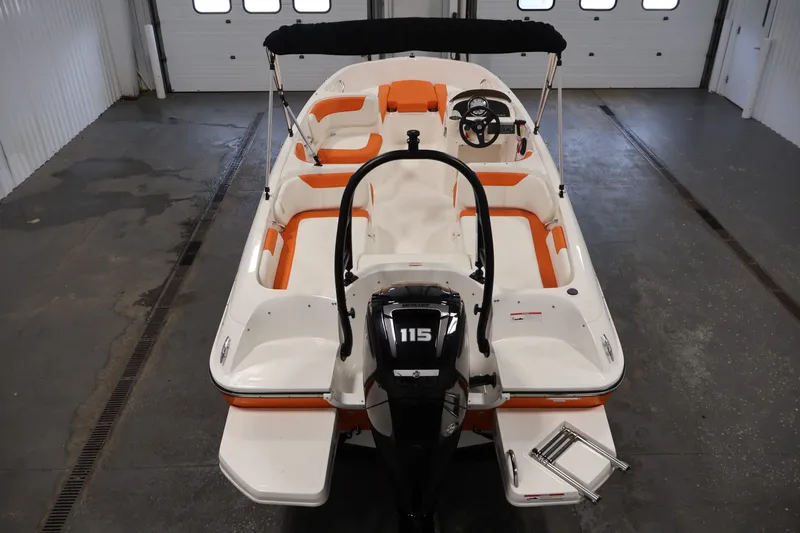 Slide: The Image of 2019 Bayliner Element 180 XL boat with orange seating, viewed from above in a garage. - 41