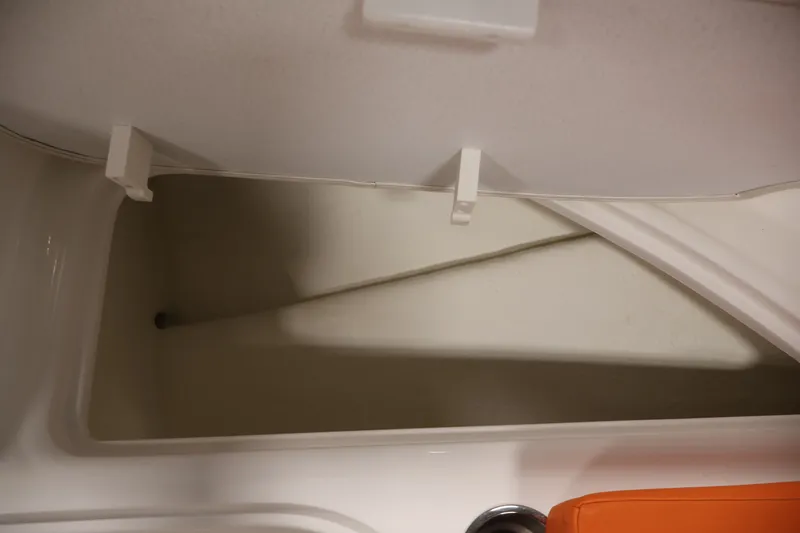 Slide: The Image of Storage compartment of a 2019 Bayliner Element 180 XL boat, open and empty. - 13