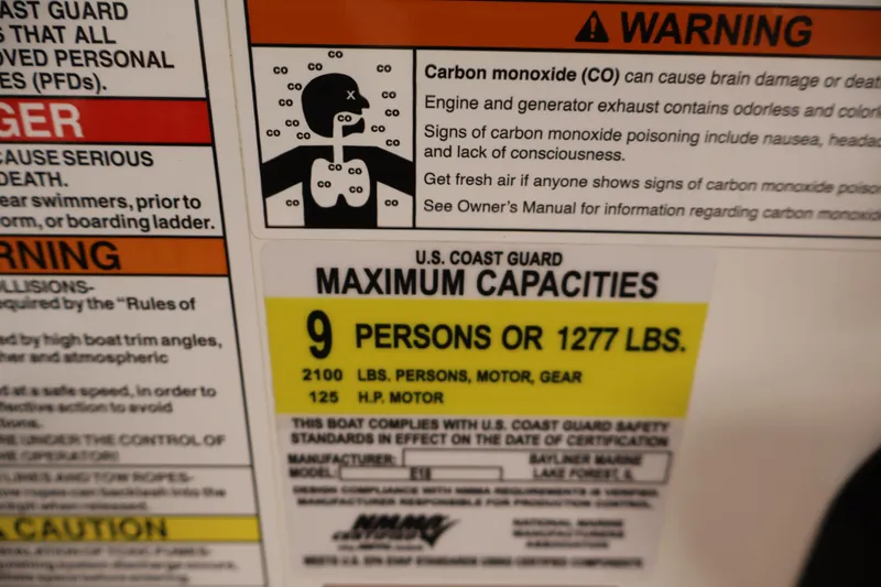 Slide: The Image of Warning label on 2019 Bayliner Element 180 XL, detailing maximum capacity and carbon monoxide risks. - 23