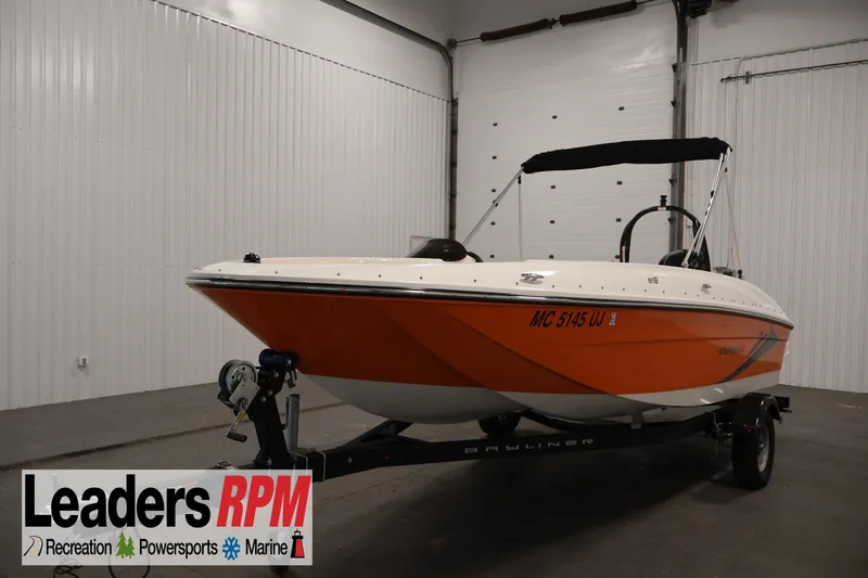 The Image of 2019 Bayliner Element 180 XL boat in a showroom, featuring an orange hull and black canopy. - 1