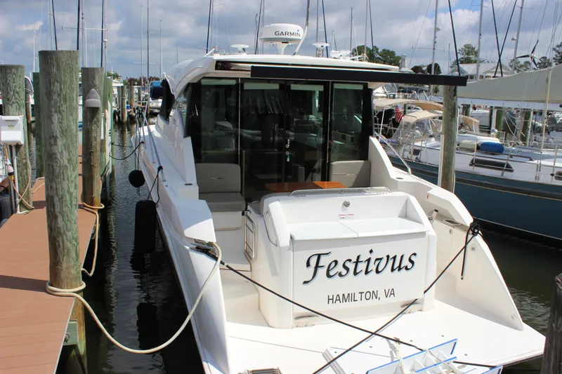 Slide: The Image of 2019 Tiara Yachts C39 Coupe docked, named "Festivus," in a marina setting. - 32
