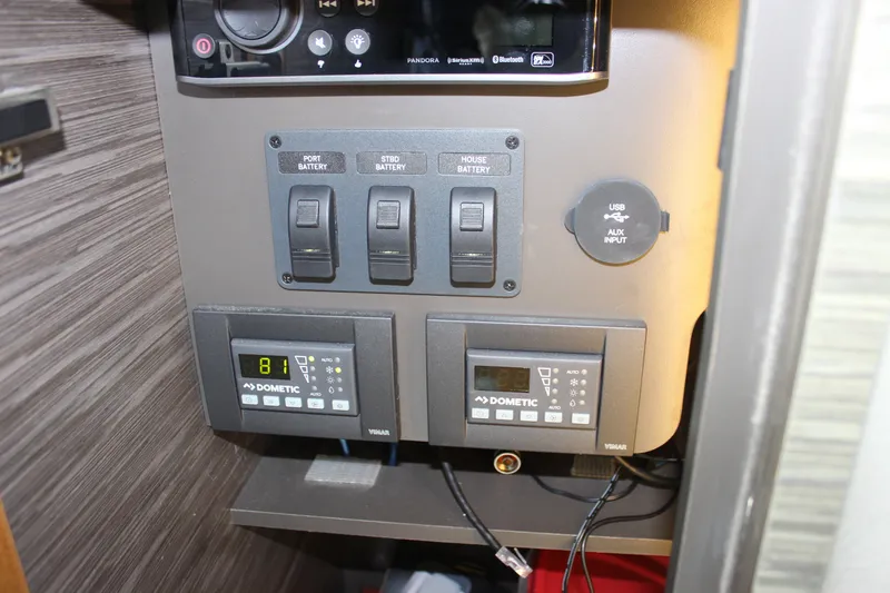 Slide: The Image of Control panel of 2019 Tiara Yachts C39 Coupe with battery switches and Dometic displays. - 58