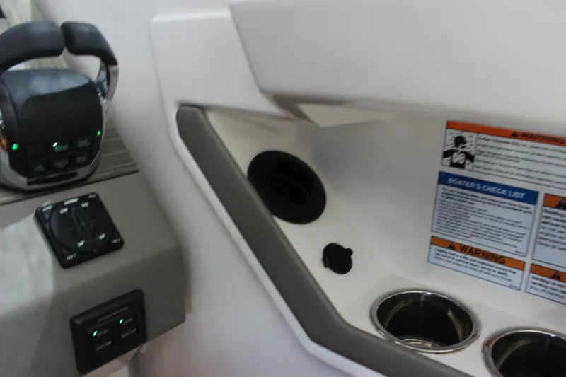 Slide: The Image of 2019 Tiara Yachts C39 Coupe cockpit controls with checklist and cup holders. - 102