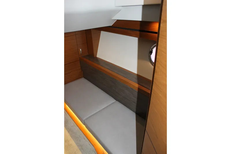 Slide: The Image of Interior of 2019 Tiara Yachts C39 Coupe, featuring sleek wood paneling and cushioned seating. - 90