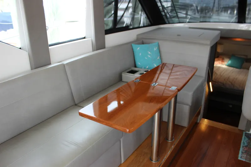 Slide: The Image of Interior of 2019 Tiara Yachts C39 Coupe, featuring sleek seating and a polished wooden table. - 61