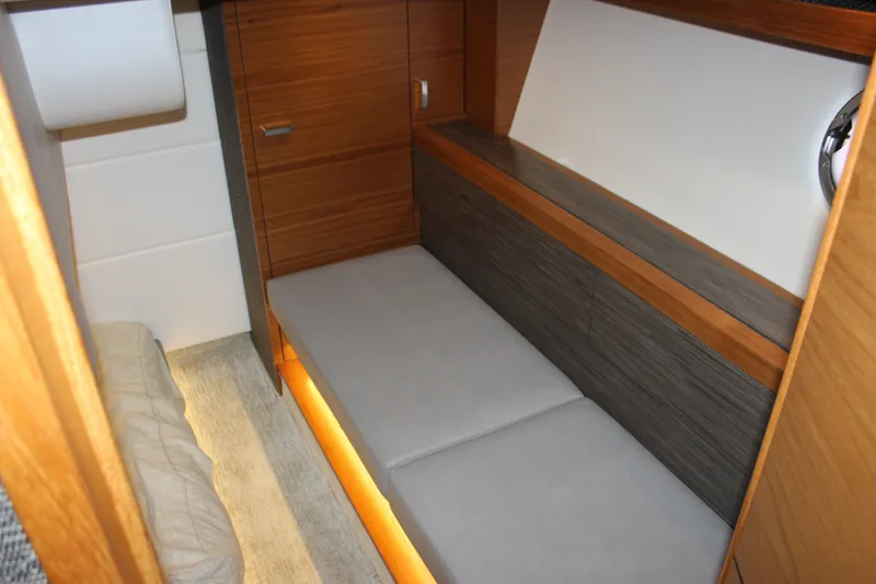 Slide: The Image of Interior of 2019 Tiara Yachts C39 Coupe, featuring sleek wood paneling and modern seating. - 88