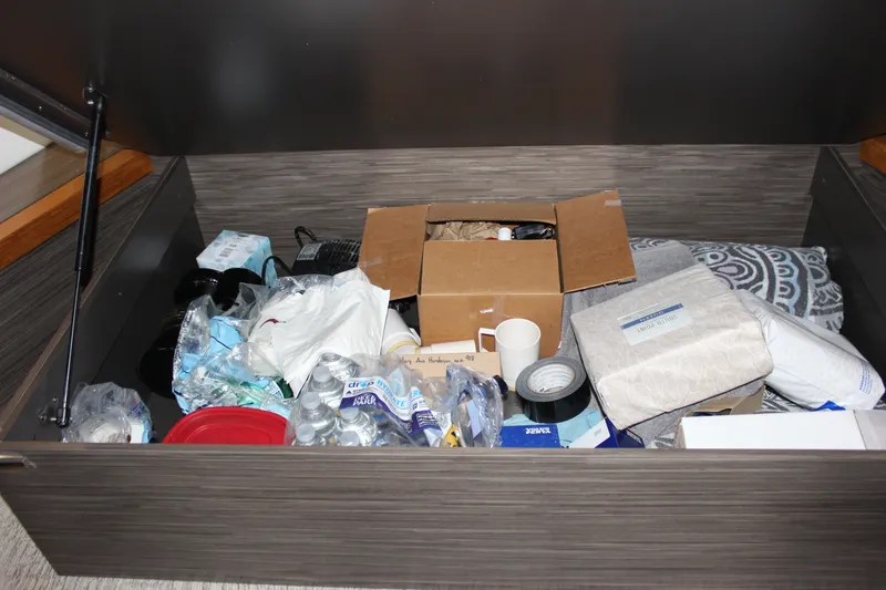 Slide: The Image of Storage compartment in 2019 Tiara Yachts C39 Coupe filled with various supplies and items. - 105