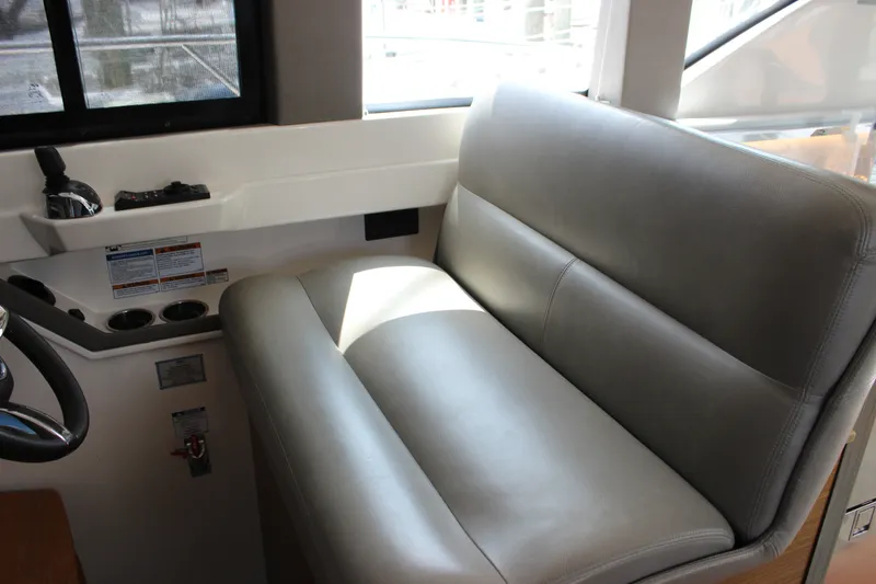 Slide: The Image of 2019 Tiara Yachts C39 Coupe interior with gray leather seating and control panel. - 103