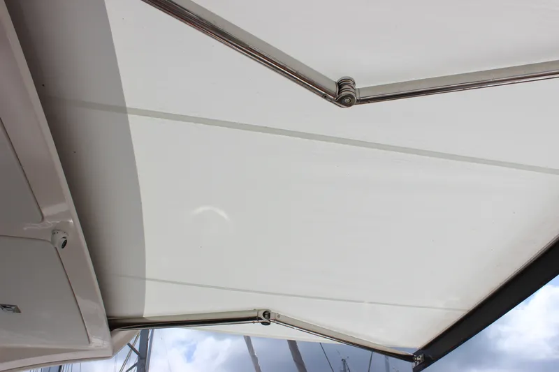 Slide: The Image of 2019 Tiara Yachts C39 Coupe retractable sunshade with metal supports, partially extended. - 26