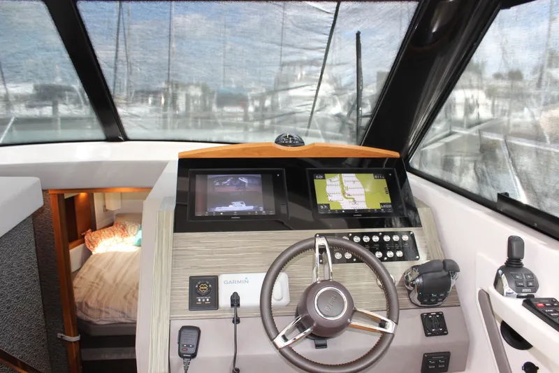 Slide: The Image of 2019 Tiara Yachts C39 Coupe helm with navigation screens and cozy cabin view. - 71
