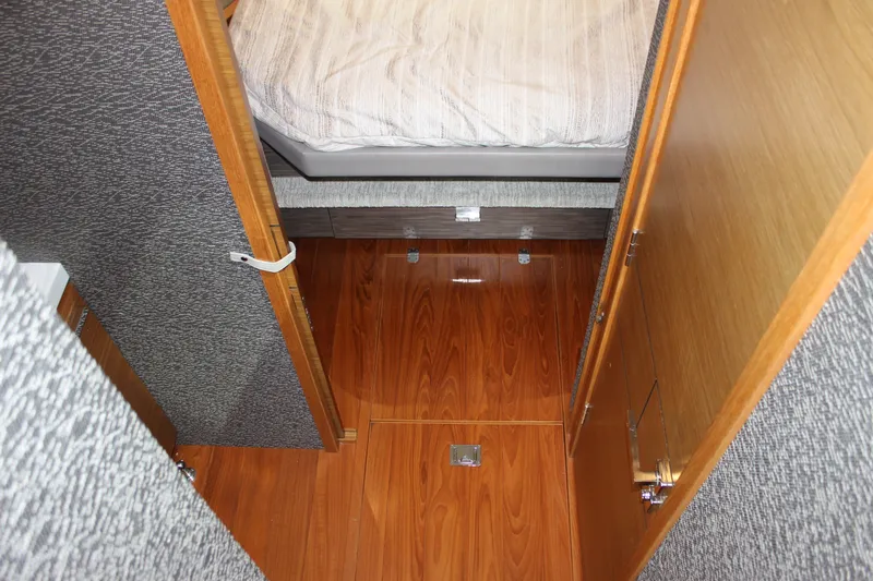 Slide: The Image of 2019 Tiara Yachts C39 Coupe interior with wooden flooring and cozy bed. - 76
