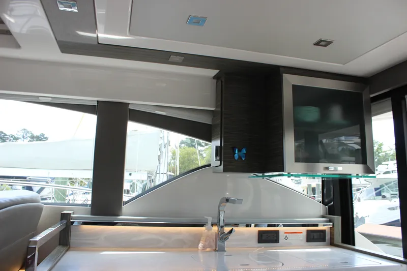 Slide: The Image of Interior of 2019 Tiara Yachts C39 Coupe, featuring modern kitchen amenities and sleek design. - 67