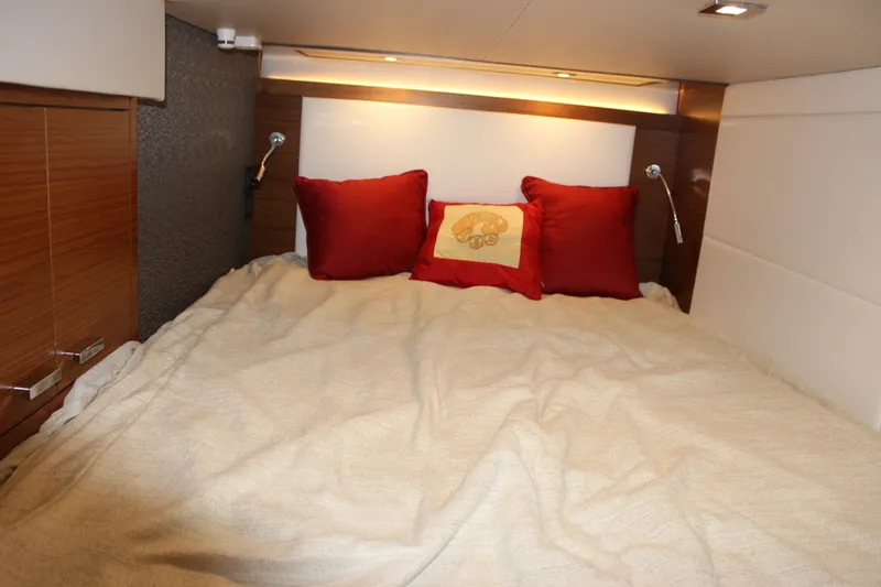 Slide: The Image of Cozy bedroom interior of 2019 Tiara Yachts C39 Coupe with red pillows and beige bedding. - 92