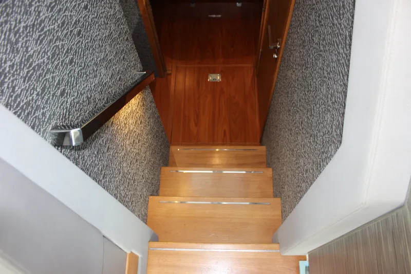 Slide: The Image of Staircase inside 2019 Tiara Yachts C39 Coupe with wooden steps and textured walls. - 75
