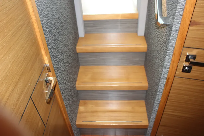 Slide: The Image of Staircase inside 2019 Tiara Yachts C39 Coupe with wooden steps and modern design. - 95