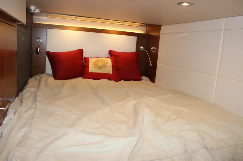 Slide: The Image of Cozy bedroom interior of 2019 Tiara Yachts C39 Coupe with red pillows and soft lighting. - 91