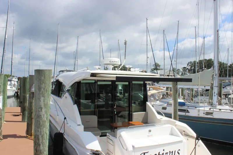 Slide: The Image of 2019 Tiara Yachts C39 Coupe docked at marina with sailboats in background. - 35