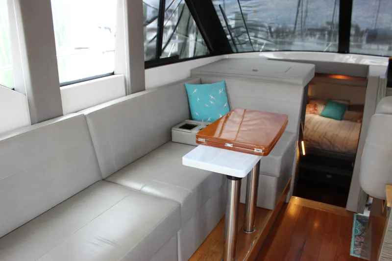 Slide: The Image of Interior of 2019 Tiara Yachts C39 Coupe, featuring elegant seating and a cozy cabin. - 59