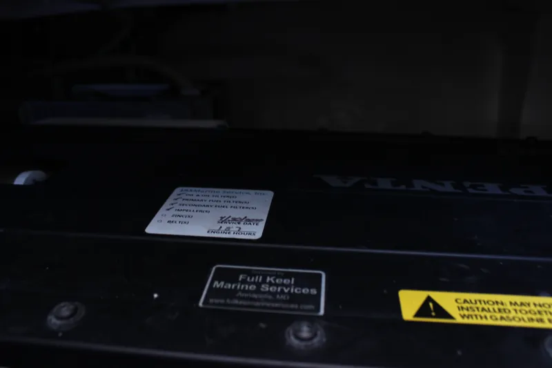 Slide: The Image of Engine compartment of 2019 Tiara Yachts C39 Coupe with service labels and caution sign. - 48
