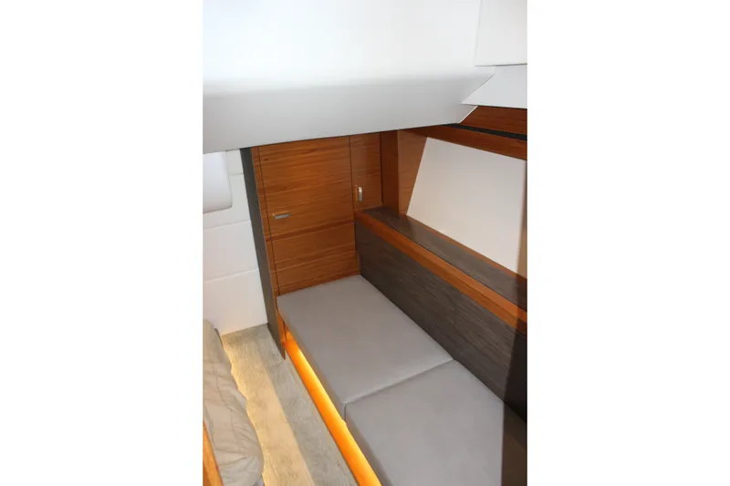 Slide: The Image of 2019 Tiara Yachts C39 Coupe interior with sleek wood paneling and modern seating. - 89