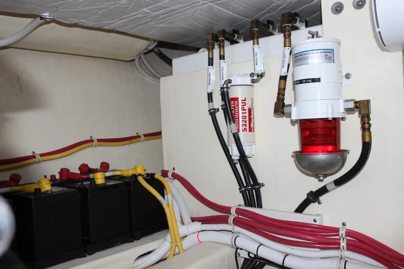 Slide: The Image of Engine room of 2019 Tiara Yachts C39 Coupe with batteries and fuel filter system. - 43