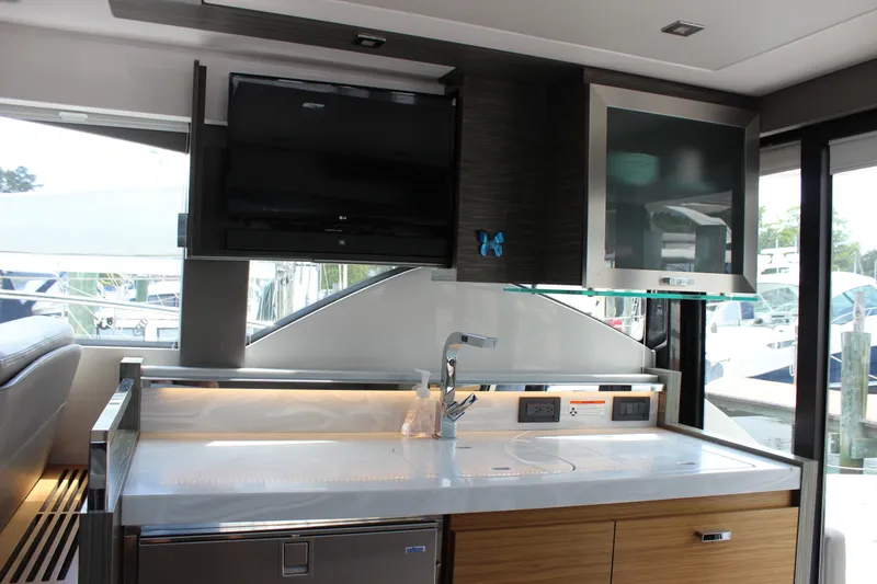 Slide: The Image of Interior of 2019 Tiara Yachts C39 Coupe featuring modern kitchen amenities. - 66