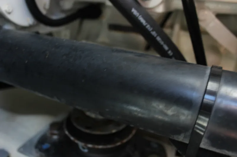 Slide: The Image of Close-up of a 2019 Tiara Yachts C39 Coupe engine component with black hoses. - 46